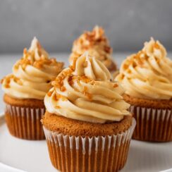 Biscoff Cupcakes combine the warm, spiced flavor of cookie butter with a moist, fluffy cupcake base. Filled with melted Biscoff spread and topped with a tangy cream cheese frosting enriched with cookie butter, these cupcakes are crowned with a Biscoff cookie for the ultimate treat. Perfect for lovers of indulgent and unique desserts.