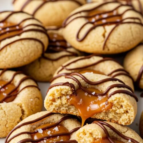 These Twix Thumbprint Cookies are filled with gooey caramel and topped with rich chocolate for the ultimate bite. It’s perfect for parties, holidays, and dessert tables.