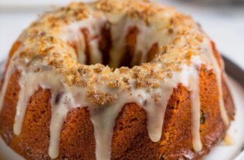 Moist and flavorful Carrot Bundt Cake packed with shredded carrots, warm spices, and a creamy glaze. Perfect for desserts or celebrations. A classic favorite!