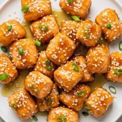 Honey Garlic Salmon Bites are a delicious and visually appealing dish that combines tender salmon with a flavorful honey garlic sauce, all served on a bed of fluffy white rice.