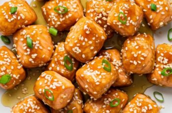 Honey Garlic Salmon Bites are a delicious and visually appealing dish that combines tender salmon with a flavorful honey garlic sauce, all served on a bed of fluffy white rice.