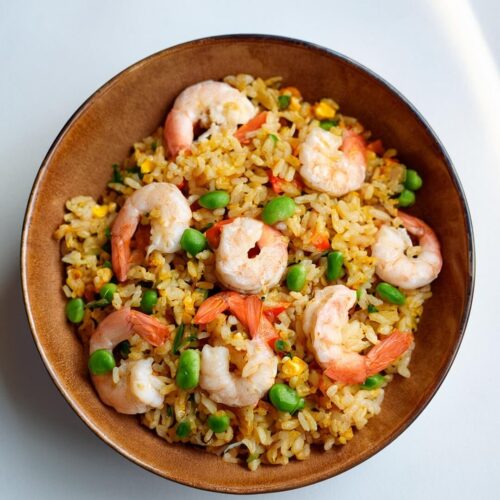 Shrimp Fried Rice is a quick and flavorful one-pan dish, combining tender shrimp, vibrant vegetables, and perfectly stir-fried jasmine rice. A blend of savory sauces and aromatics ties the dish together, while a touch of sriracha adds a spicy kick. Perfect for a satisfying meal any night of the week!