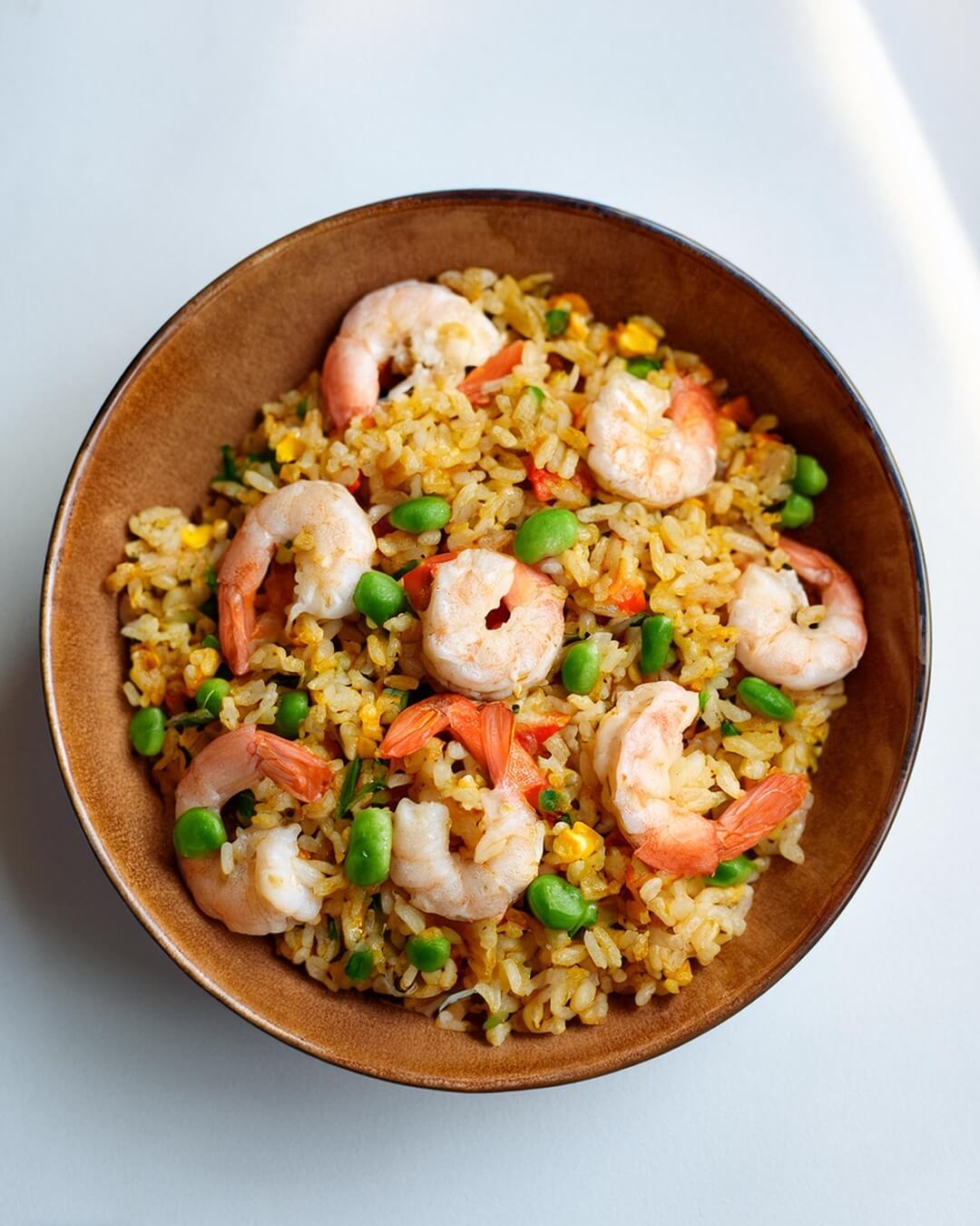 Shrimp Fried Rice is a quick and flavorful one-pan dish, combining tender shrimp, vibrant vegetables, and perfectly stir-fried jasmine rice. A blend of savory sauces and aromatics ties the dish together, while a touch of sriracha adds a spicy kick. Perfect for a satisfying meal any night of the week!