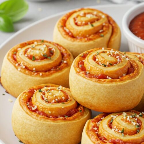 These homemade pizza rolls are stuffed with gooey mozzarella, zesty marinara, and optional pepperoni for the ultimate snack.