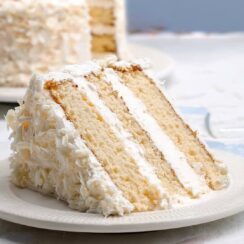 This Coconut Cake is soft, fluffy, and bursting with tropical flavor! Coconut milk, shredded coconut, and a creamy coconut buttercream make it irresistible
