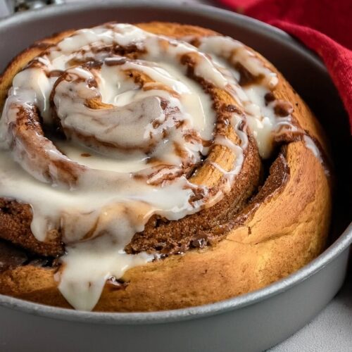 Giant Cinnamon Roll with Cream Cheese Frosting is the ultimate cozy indulgence—a supersized version of the classic breakfast favorite, swirled with cinnamon sugar and topped with rich, tangy cream cheese frosting. This stunning treat is soft, gooey, and perfect for sharing!