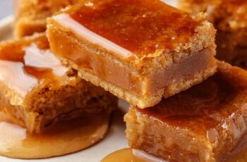 Gooey Maple Syrup Bars are a rich and decadent dessert featuring a buttery shortbread crust topped with a gooey maple filling. These bars are perfect for any occasion, offering a deep maple flavor and a satisfying texture.