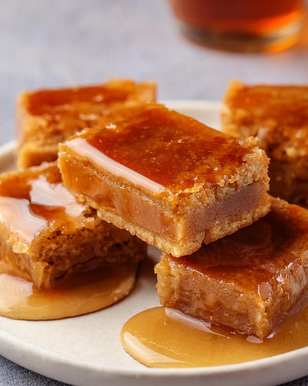 Gooey Maple Syrup Bars are a rich and decadent dessert featuring a buttery shortbread crust topped with a gooey maple filling. These bars are perfect for any occasion, offering a deep maple flavor and a satisfying texture.