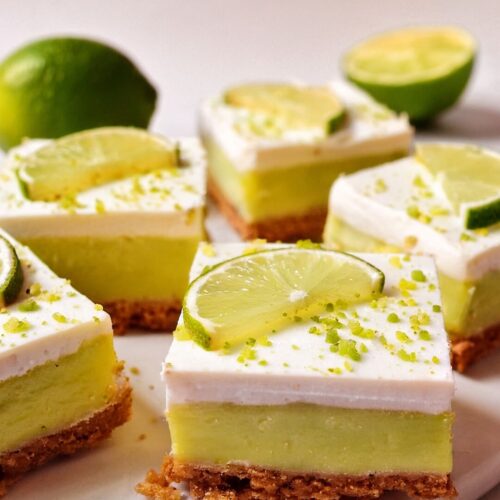Key Lime Pie Bars are a tangy, creamy dessert with a buttery crust, a smooth lime filling, and a layer of fluffy whipped topping.