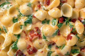 Tuscan Mac and Cheese is the ultimate comfort dish with sun-dried tomatoes, baby spinach, and three cheeses in a creamy herb sauce over tender shells. So dreamy!