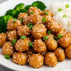 Crispy, juicy sesame chicken tossed in a sticky-sweet, garlicky sauce, served over fluffy jasmine rice and topped with scallions and sesame seeds