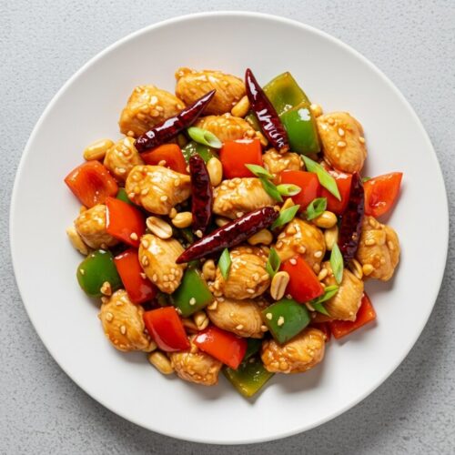 Kung Pao Chicken—sweet, spicy, crunchy, and bold! Packed with tender chicken, veggies, and peanuts over jasmine rice for a perfect takeout-style meal