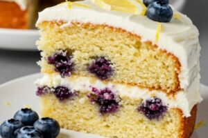 The Lemon Blueberry Cake bursts with citrusy zest, juicy berries, and a rich cream cheese frosting, making it the perfect fruity dessert for any occasion.