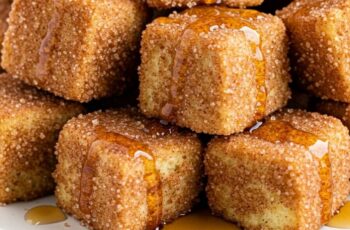 Cinnamon French Toast Bites with Maple Syrup are bite-sized pieces of golden, custardy French toast, perfectly spiced with cinnamon and served with a drizzle of sweet maple syrup.