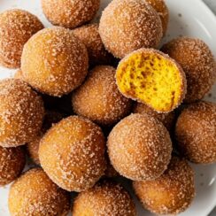 Soft, spiced pumpkin donut holes coated in cinnamon sugar. Perfectly tender bites bursting with cozy fall flavors in every bite.