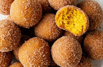 Soft, spiced pumpkin donut holes coated in cinnamon sugar. Perfectly tender bites bursting with cozy fall flavors in every bite.