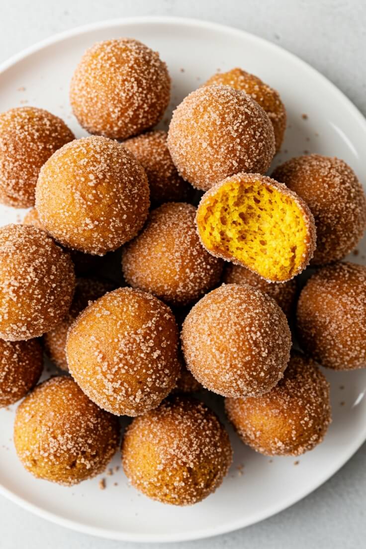 Soft, spiced pumpkin donut holes coated in cinnamon sugar. Perfectly tender bites bursting with cozy fall flavors in every bite.